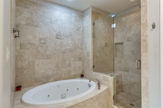 a bathroom with a bathtub and shower