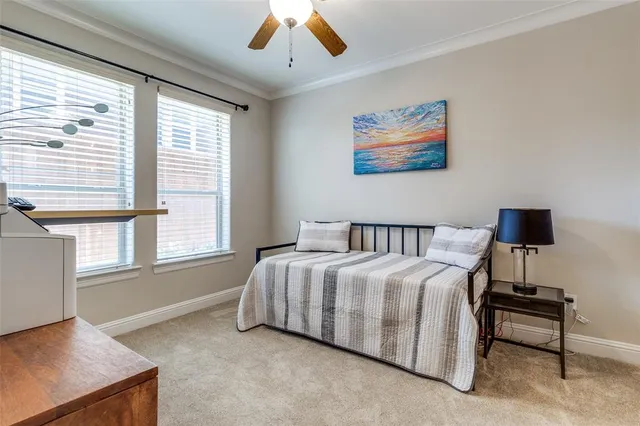 a spacious bedroom with a bed and a large window