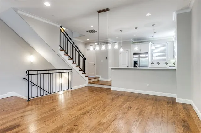 a view of a kitchen with furniture and wooden floor