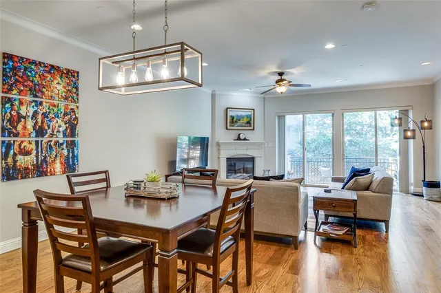 a dining room with furniture a fireplace and wooden floor