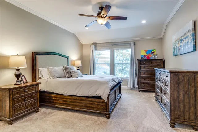 a spacious bedroom with a bed and a chandelier