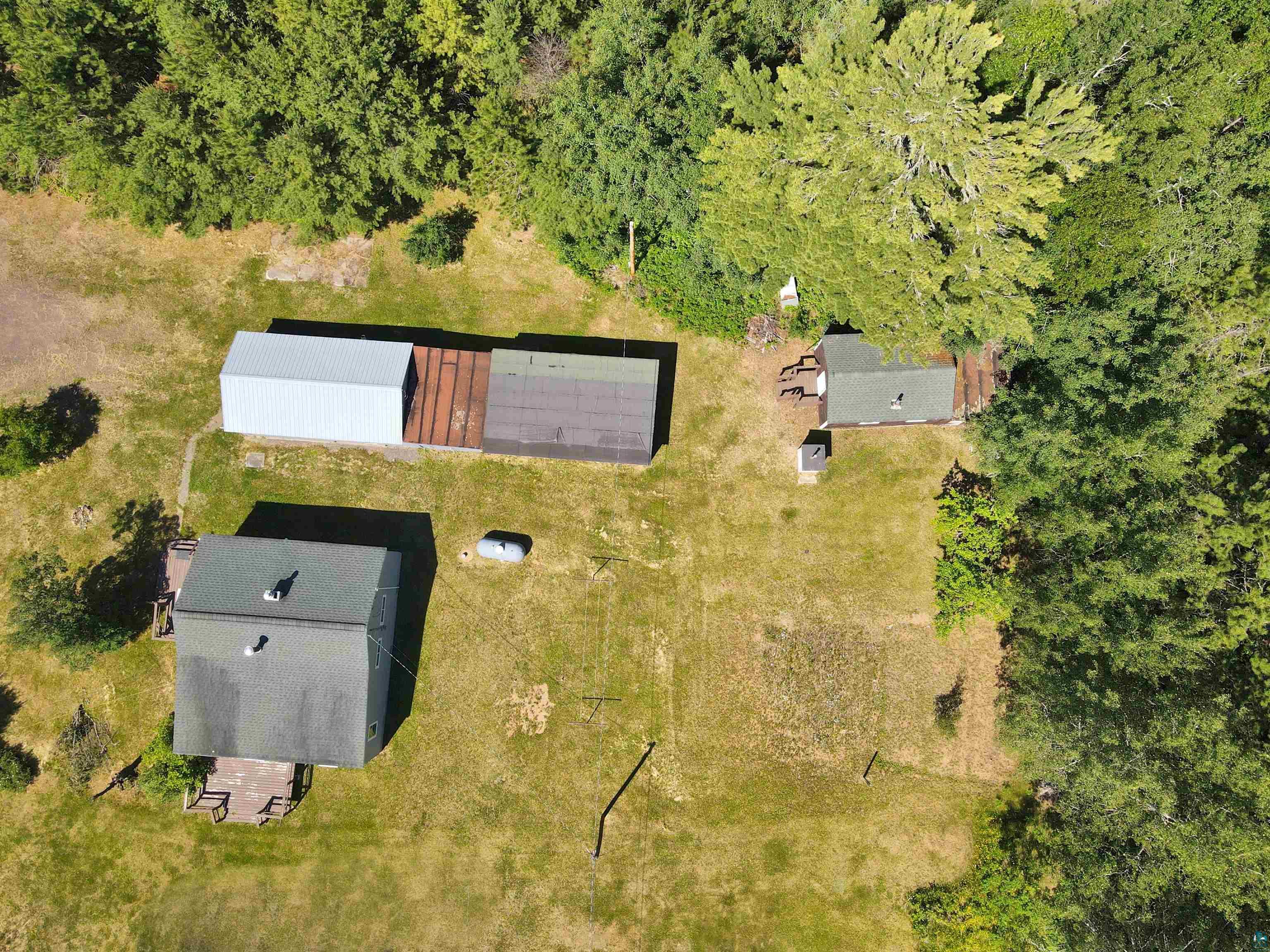 9724 State Highway 1 Isabella, MN 55607 - Photo 19 of 19 Overhead property view featuring a primary structure with a dark roof, an additional smaller structure with a dark roof, and a large multi-section outbuilding
