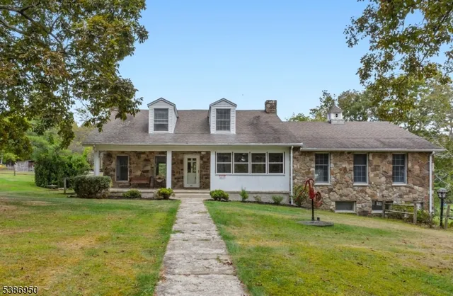 a front view of a house with a yard table and chairs