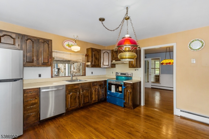 87 Glen Road Wantage, NJ 07461 - Photo 11 of 40 a kitchen with stainless steel appliances granite countertop a stove and a refrigerator