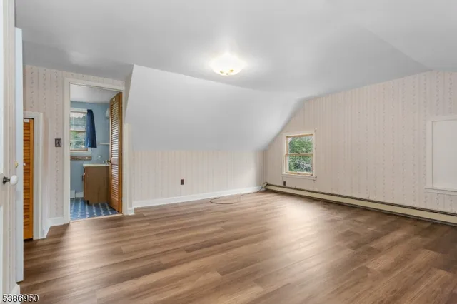 a view of a room with wooden floor