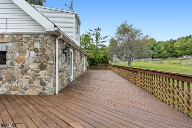 a view of a wooden deck with a yard