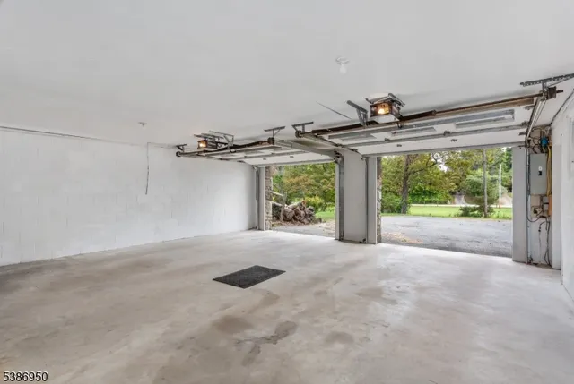 a view of a room with large windows and wooden fence