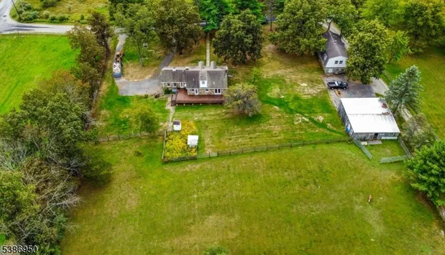 an aerial view of a house with a yard basket ball court and outdoor seating