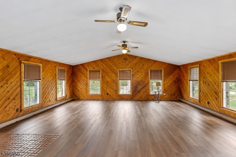 87 Glen Road Wantage, NJ 07461 - Photo 9 of 40 a view of an empty room with wooden floor and a window