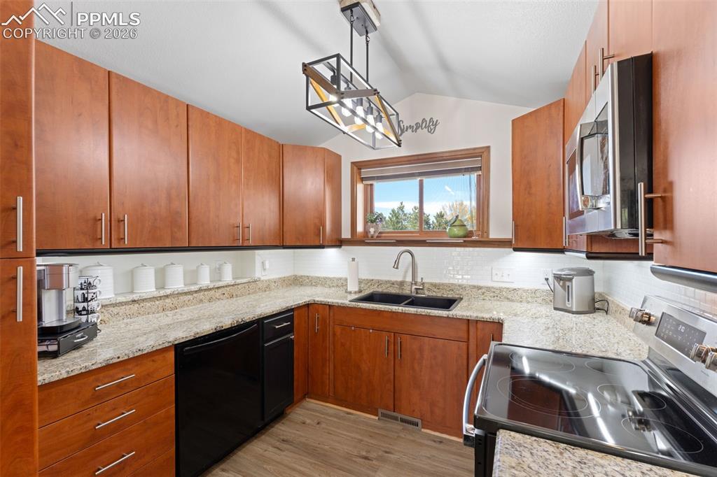 1851 Buttercup Road Elizabeth, CO 80107 - Photo 22 of 47 a kitchen with a sink cabinets and window