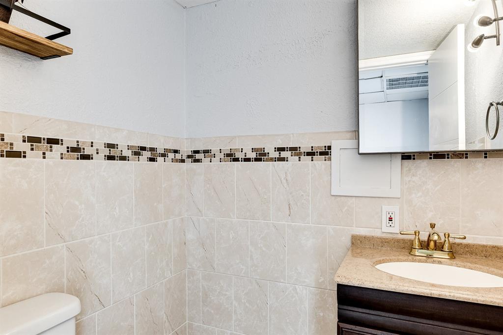 9080 Lime Bay Boulevard, Unit 109 Tamarac, FL 33321 - Photo 13 of 49 a bathroom with a sink and a mirror