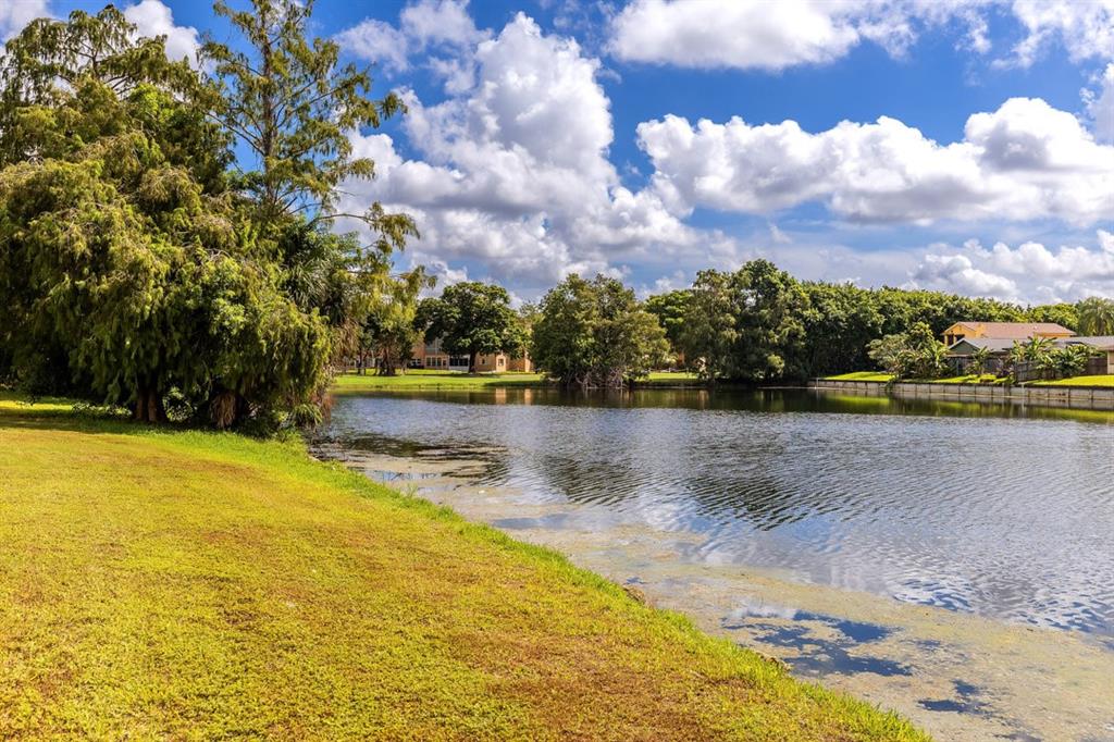 9080 Lime Bay Boulevard, Unit 109 Tamarac, FL 33321 - Photo 17 of 49 a view of a swimming pool with an outdoor seating and a yard