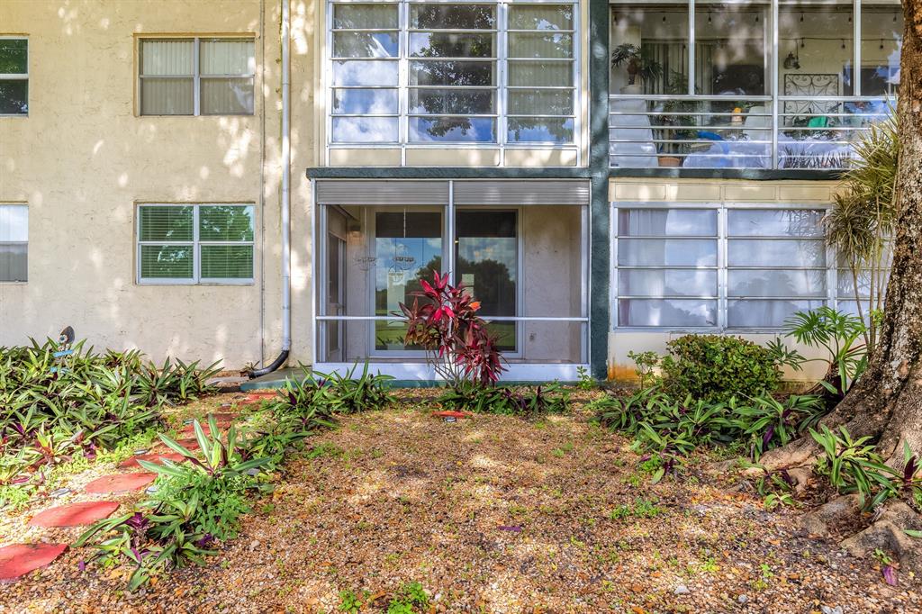 9080 Lime Bay Boulevard, Unit 109 Tamarac, FL 33321 - Photo 18 of 49 a front view of a building with garden