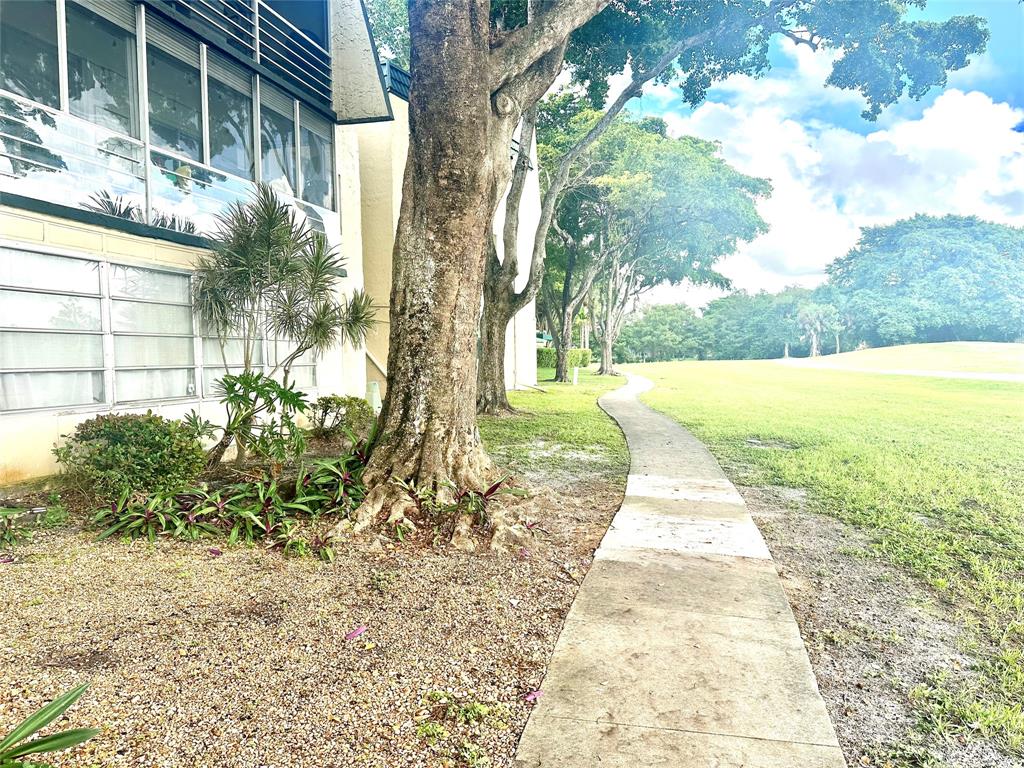 9080 Lime Bay Boulevard, Unit 109 Tamarac, FL 33321 - Photo 2 of 49 a view of a yard with plants and trees