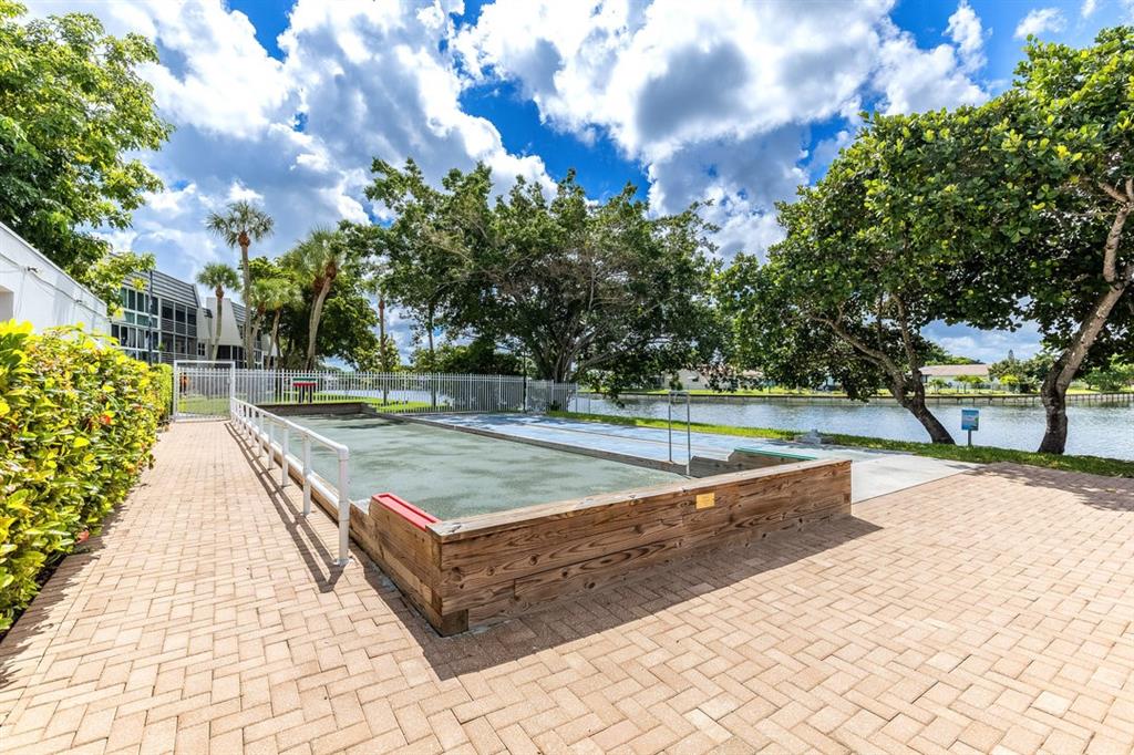 9080 Lime Bay Boulevard, Unit 109 Tamarac, FL 33321 - Photo 22 of 49 a view of a swimming pool with a yard