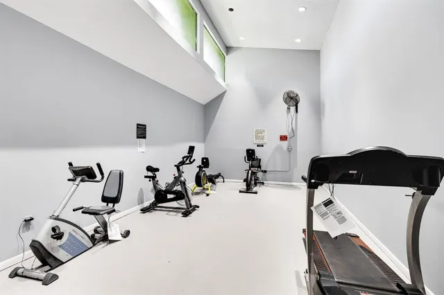a room with gym equipment and view of living room