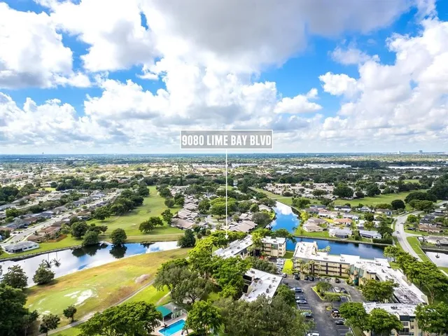 an aerial view of residential building and car parked