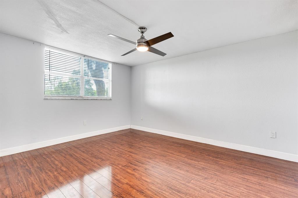 9080 Lime Bay Boulevard, Unit 109 Tamarac, FL 33321 - Photo 39 of 49 wooden floor in an empty room with a window