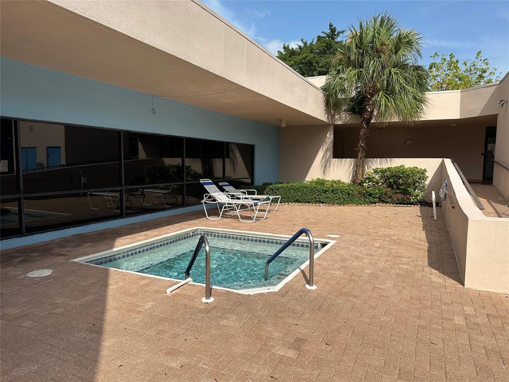 9080 Lime Bay Boulevard, Unit 109 Tamarac, FL 33321 - Photo 45 of 49 a view of outdoor living space with kitchen island and stainless steel appliances