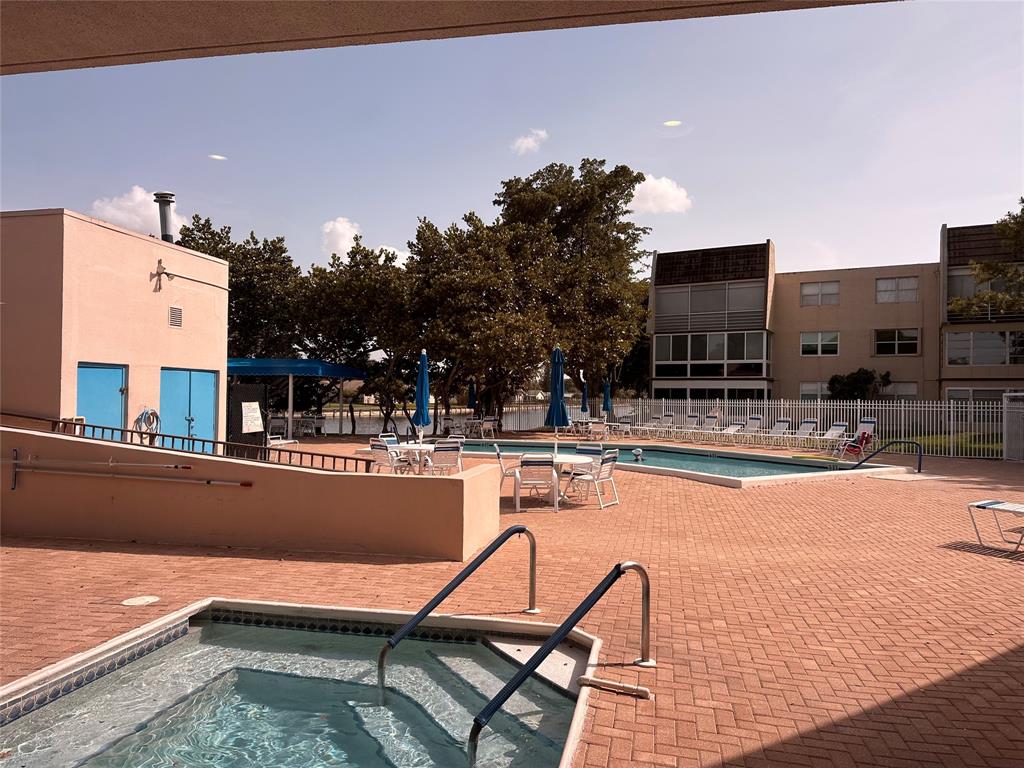 9080 Lime Bay Boulevard, Unit 109 Tamarac, FL 33321 - Photo 48 of 49 a swimming pool with outdoor seating and yard