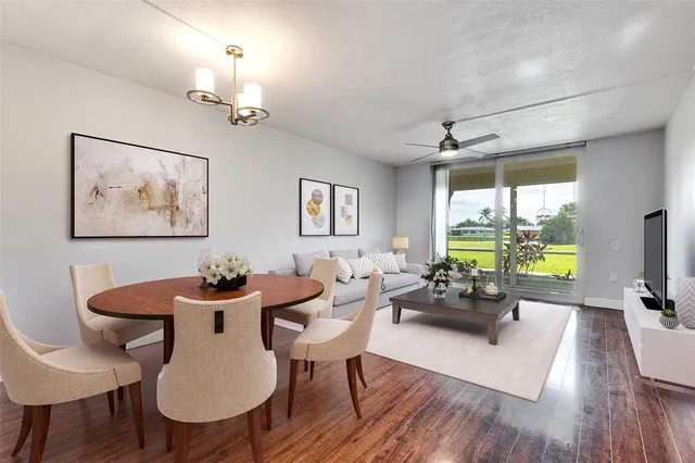 a view of a dining room with furniture window and wooden floor