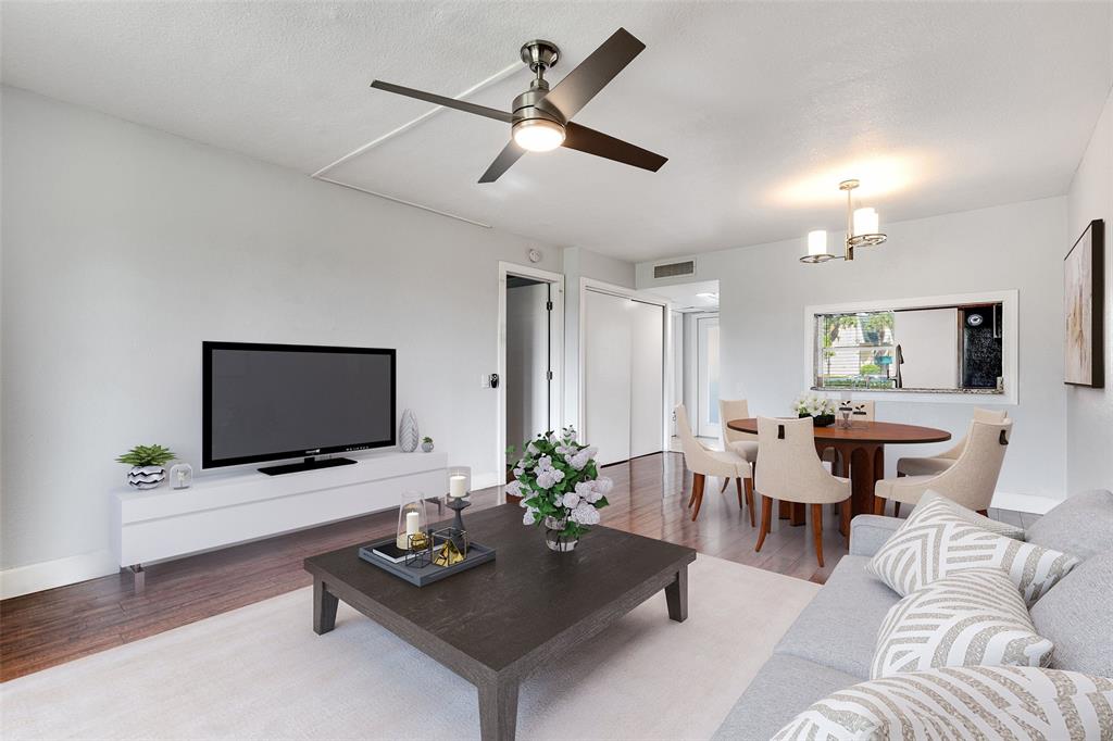 9080 Lime Bay Boulevard, Unit 109 Tamarac, FL 33321 - Photo 9 of 49 a living room with furniture and a flat screen tv