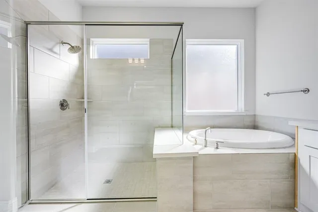 a bathroom with a tub and shower