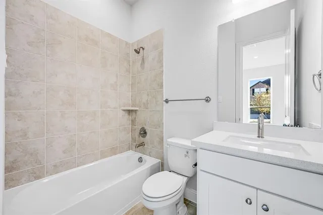 a bathroom with a sink toilet vanity and shower