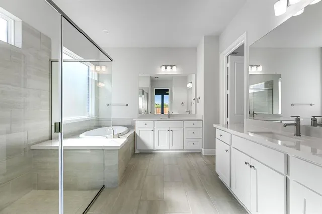 a spacious bathroom with a granite countertop sink mirror and a