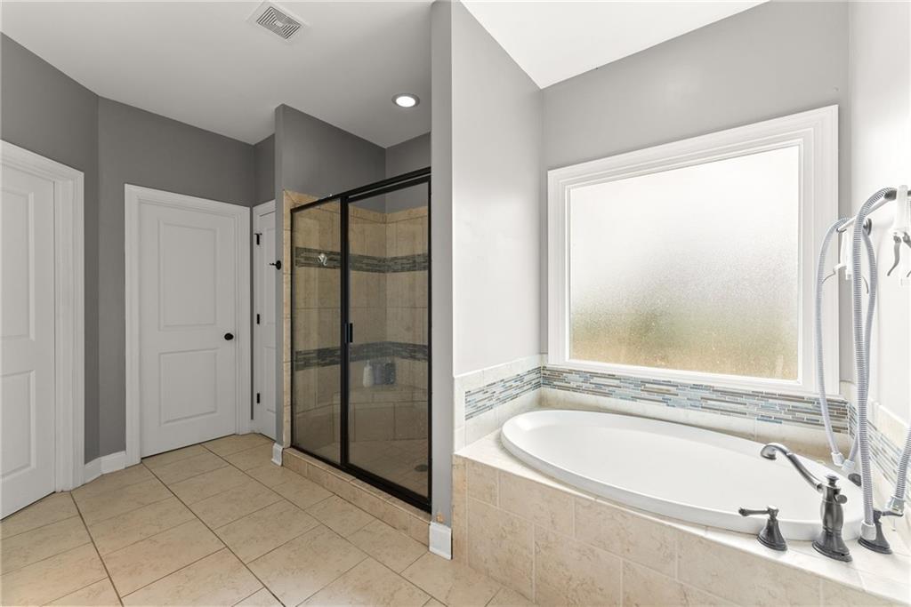 5716 Brickhampton Court Clermont, GA 30527 - Photo 20 of 42 a bathroom with a tub shower and sink