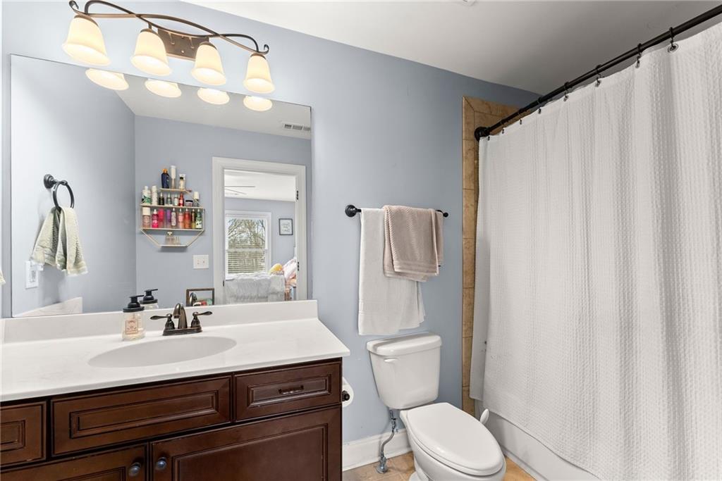 5716 Brickhampton Court Clermont, GA 30527 - Photo 22 of 42 a bathroom with a sink vanity mirror and toilet