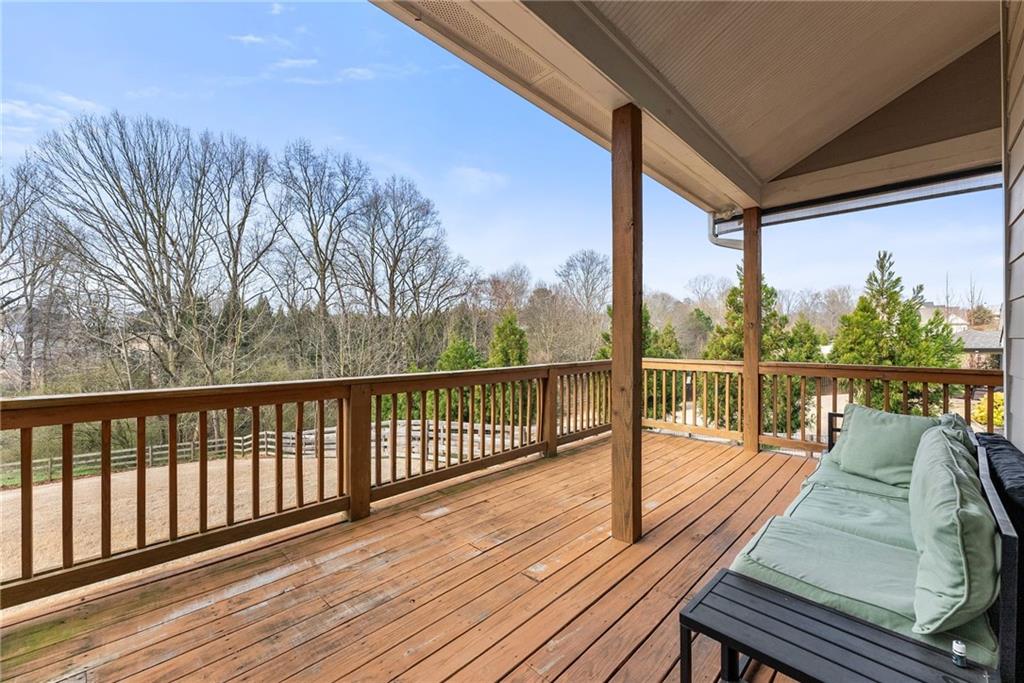 5716 Brickhampton Court Clermont, GA 30527 - Photo 28 of 42 a view of balcony with wooden floor and fence