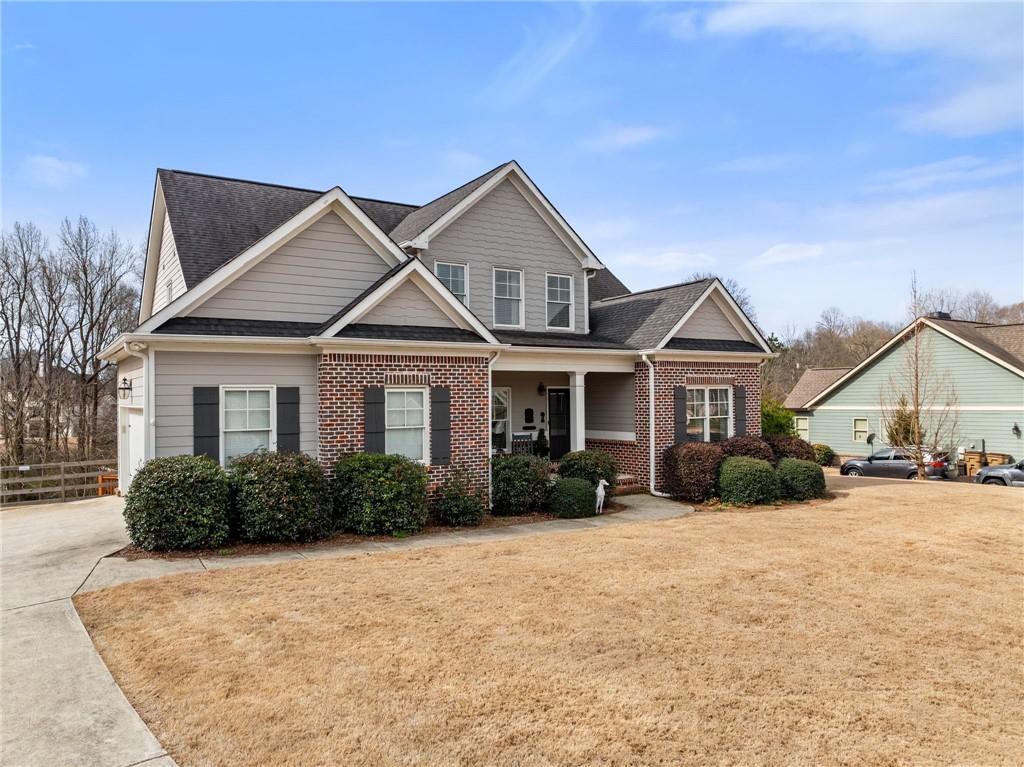 5716 Brickhampton Court Clermont, GA 30527 - Photo 4 of 42 a front view of a house with yard and green space