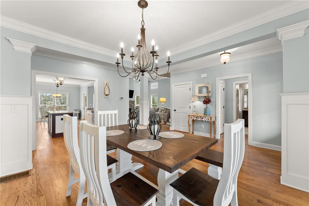 5716 Brickhampton Court Clermont, GA 30527 - Photo 10 of 42 a view of a dining room with furniture and wooden floor