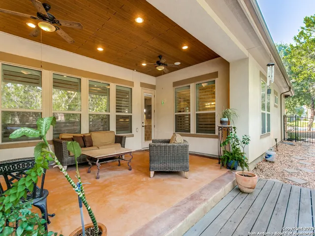 a balcony with furniture and wooden floor