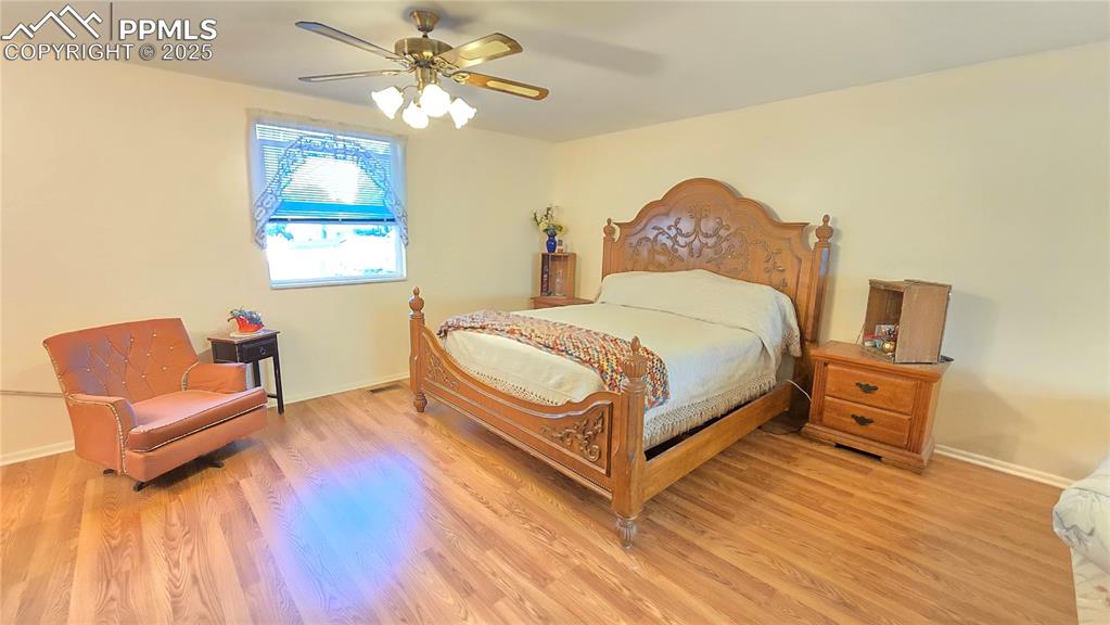 7231 South Webster Street Littleton, CO 80128 - Photo 12 of 44 Bedroom featuring a ceiling fan and light wood finished floors