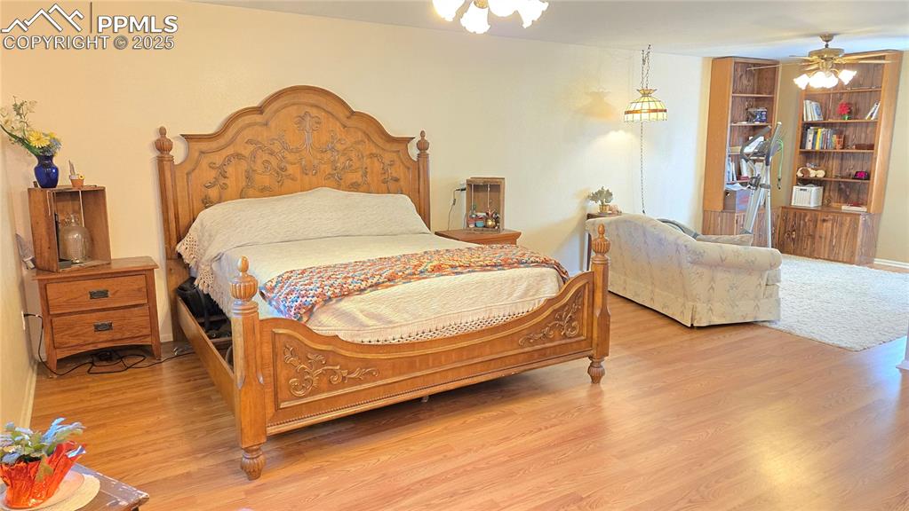 7231 South Webster Street Littleton, CO 80128 - Photo 13 of 44 a bedroom with a bed and wooden floor