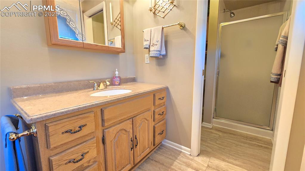 7231 South Webster Street Littleton, CO 80128 - Photo 15 of 44 Bathroom featuring a stall shower and vanity