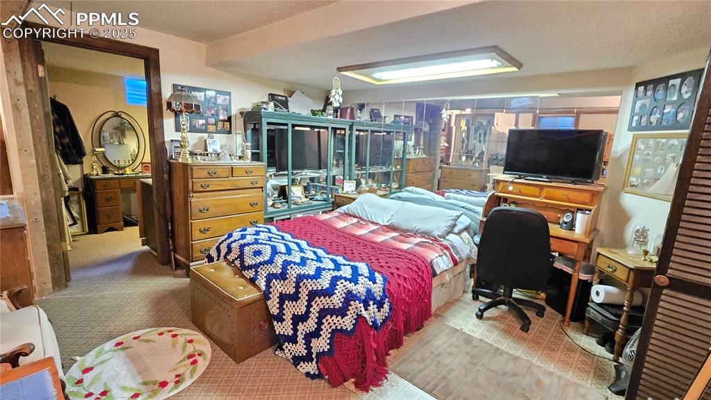 7231 South Webster Street Littleton, CO 80128 - Photo 25 of 44 a bedroom with a bed a flat screen tv and dresser