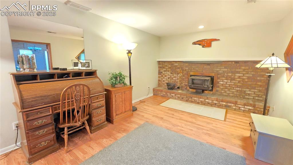 7231 South Webster Street Littleton, CO 80128 - Photo 29 of 44 a spacious bedroom with a bed a chandelier and flat screen tv