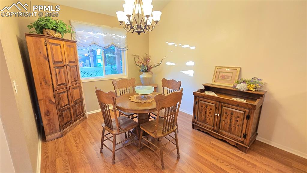 7231 South Webster Street Littleton, CO 80128 - Photo 9 of 44 a view of a dining room with furniture and chandelier