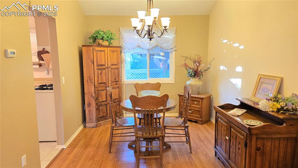 7231 South Webster Street Littleton, CO 80128 - Photo 10 of 44 a view of a dining room with furniture and wooden floor
