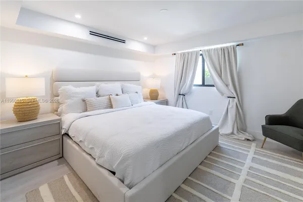 a large white bed in a white room