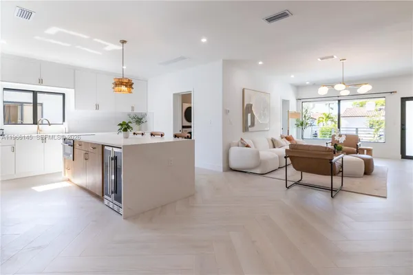 a living room with furniture and kitchen view
