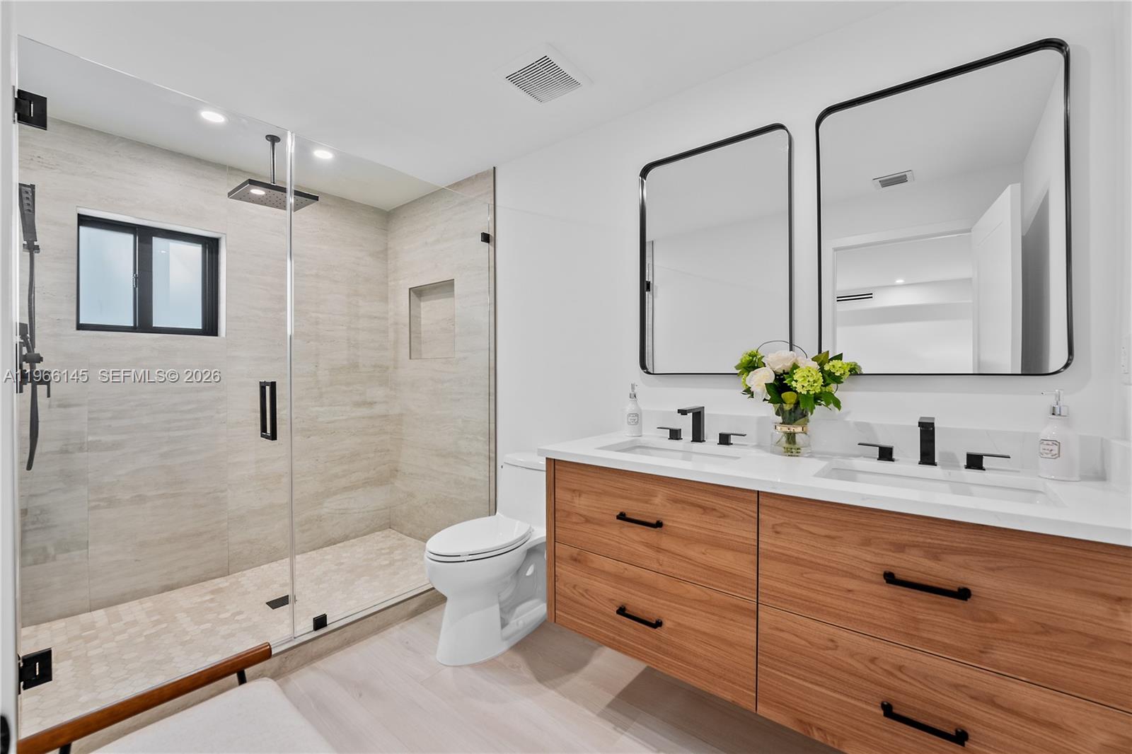 1420 Southwest 17th Street Miami, FL 33145 - Photo 31 of 49 a bathroom with a double vanity sink toilet mirror and shower