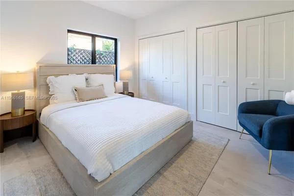 a bedroom with a bed and a couch