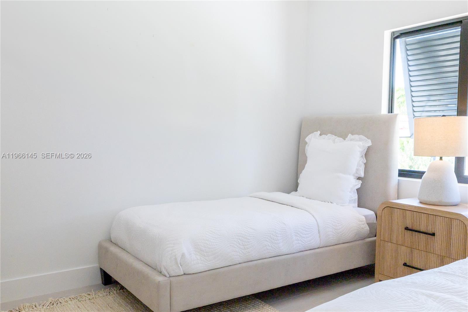 1420 Southwest 17th Street Miami, FL 33145 - Photo 39 of 49 a bedroom with a bed and a lamp