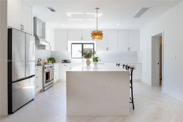 a kitchen with refrigerator and window
