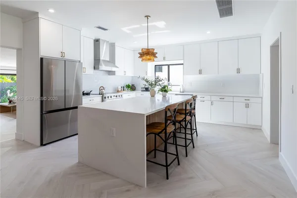 a kitchen with refrigerator cabinets and a center island