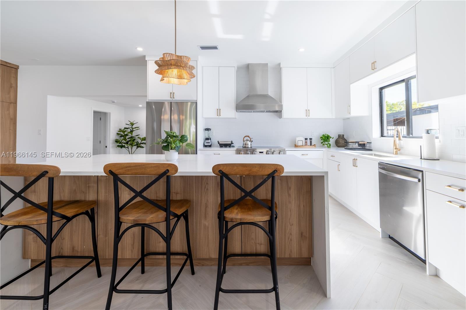 1420 Southwest 17th Street Miami, FL 33145 - Photo 8 of 49 a kitchen with stainless steel appliances granite countertop table chairs sink and cabinets
